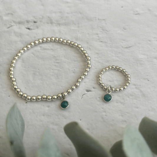 Sterling silver beaded bracelet and ring set with emerald green crystal charms – a handcrafted May birthstone jewellery gift.