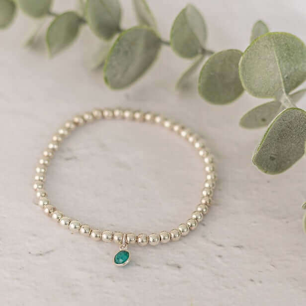 Sterling silver bead bracelet with emerald green charm – a meaningful May birthstone bracelet, handmade and gift-ready.