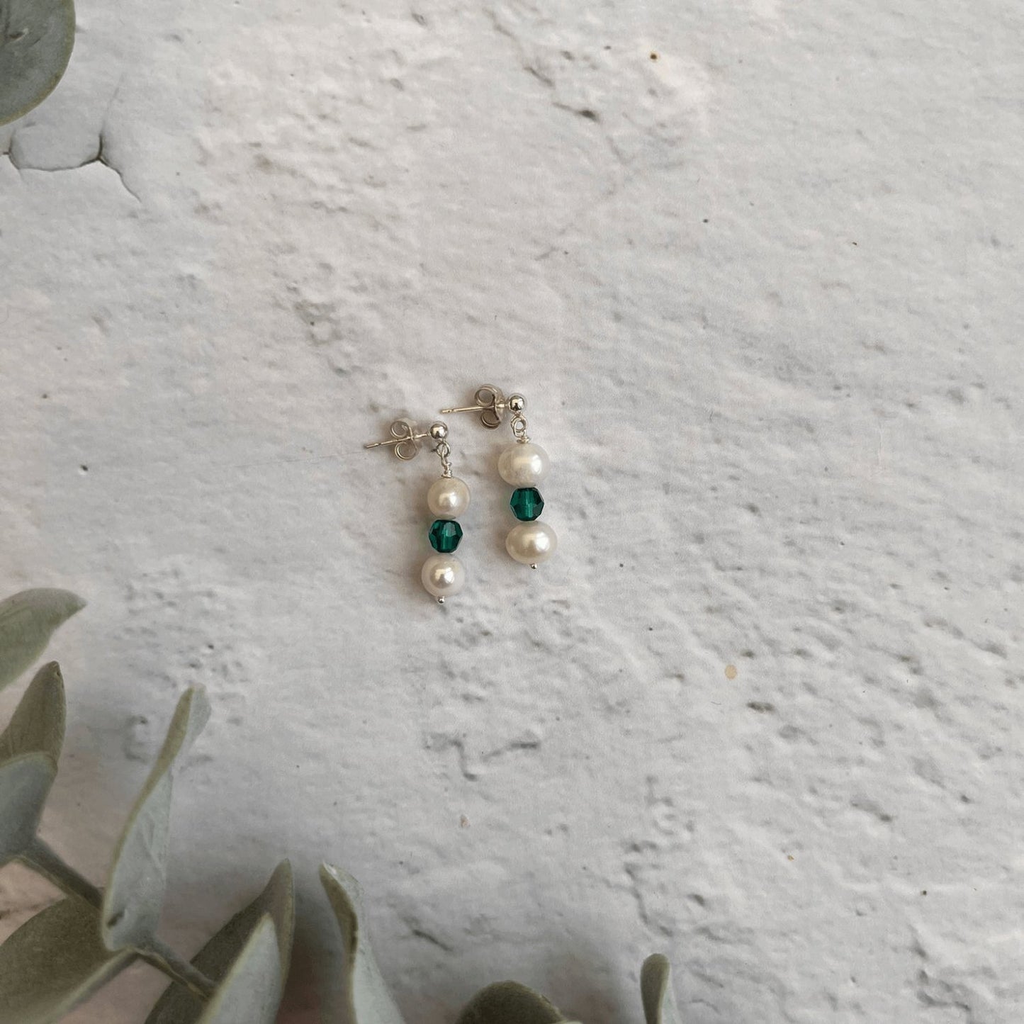 Handmade sterling silver drop earrings with freshwater pearls and emerald green crystals – a thoughtful May birthstone gift.