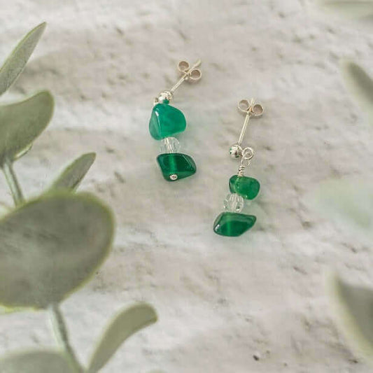 Sterling silver green agate drop earrings handcrafted with natural gemstone chips, styled on a soft stone background – elegant May birthstone earrings.