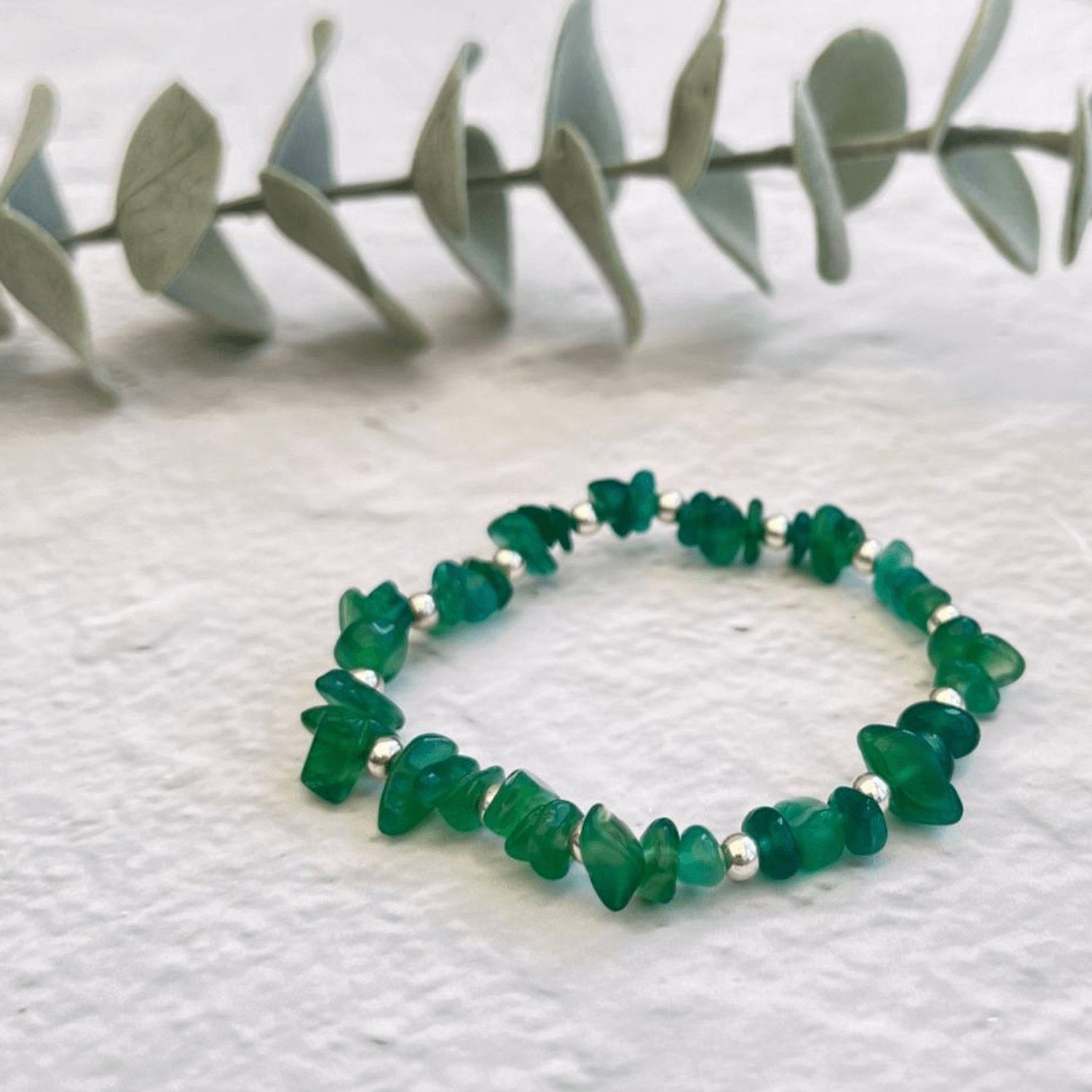 Isolated image of green agate crystal bracelet made with sterling silver accents – minimalist chip bead design for crystal jewellery lovers.