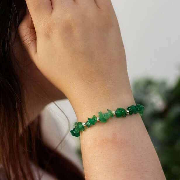 Close-up of woman wearing green agate chip bracelet with a calm, nature-inspired look – handmade May birthstone bracelet gift idea.