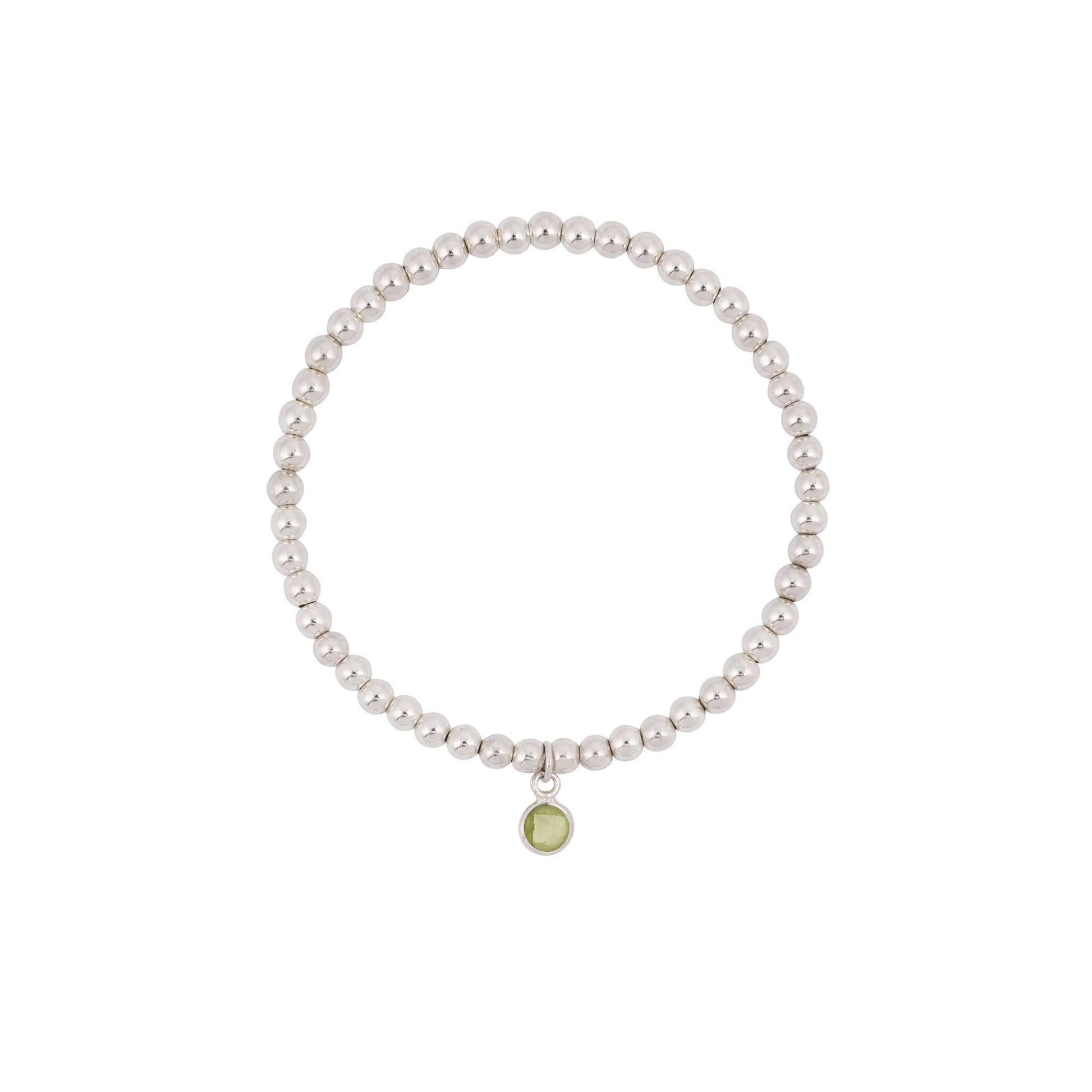Peridot birthstone bracelet on white background with beaded design and charm