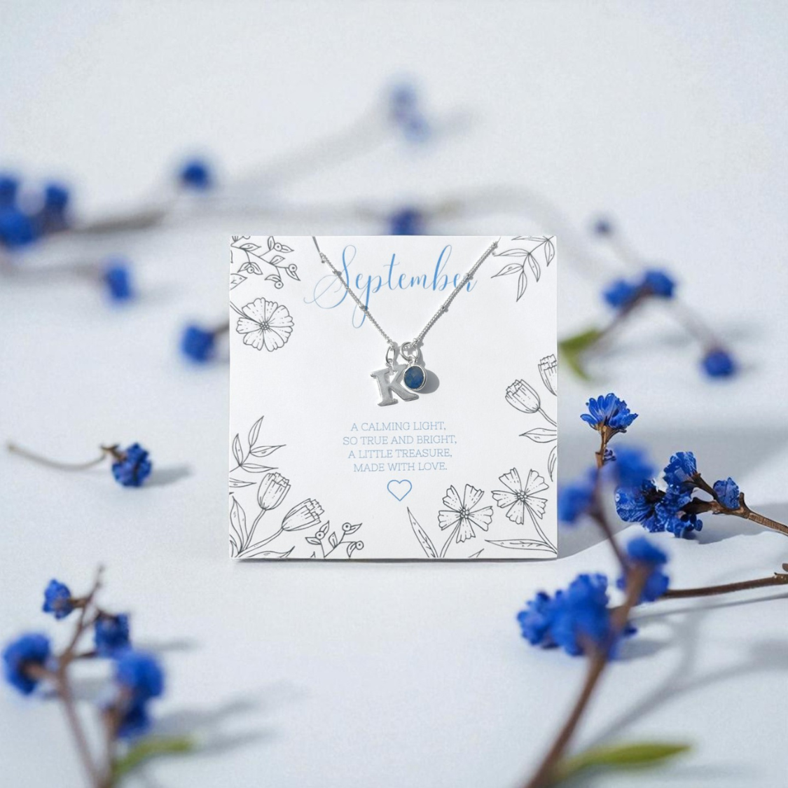 Personalised September birthstone necklace with sapphire charm and silver initial pendant, handmade meaningful jewellery gift for women UK by Made Here With Love.