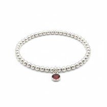 January birthstone garnet charm bracelet with rich red gemstone and sterling silver stretch beads.