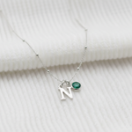 Initial and May emerald birthstone necklace with delicate green gemstone charm