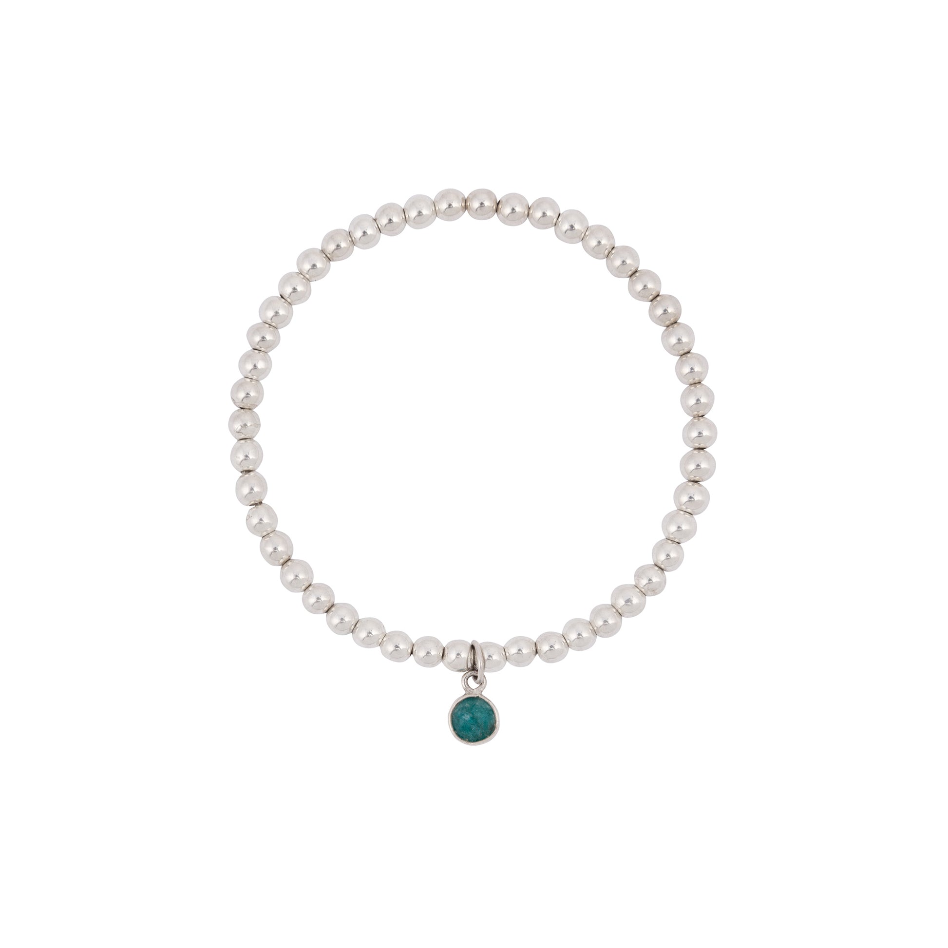 The Made Here with Love Emerald May Birthstone Bracelet is a sterling silver bracelet with uniformly round, smooth beads that form a complete circle, featuring a small green circular pendant representing the May birthstone. The pendant adds a touch of color to the sleek and elegant design.