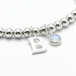 Personalised June birthstone stretch bracelet in sterling silver beads with moonstone charm
