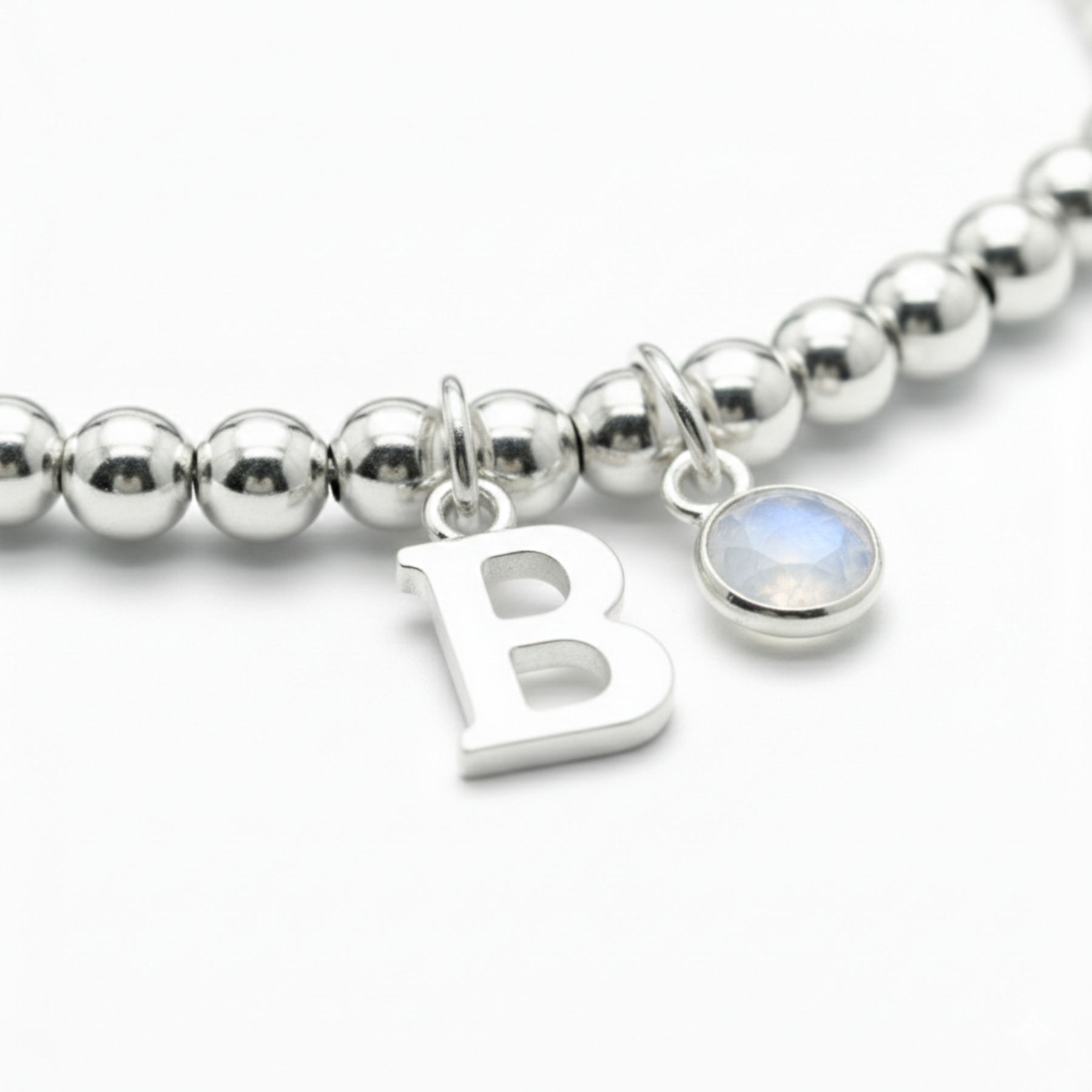 Personalised June birthstone stretch bracelet in sterling silver beads with moonstone charm