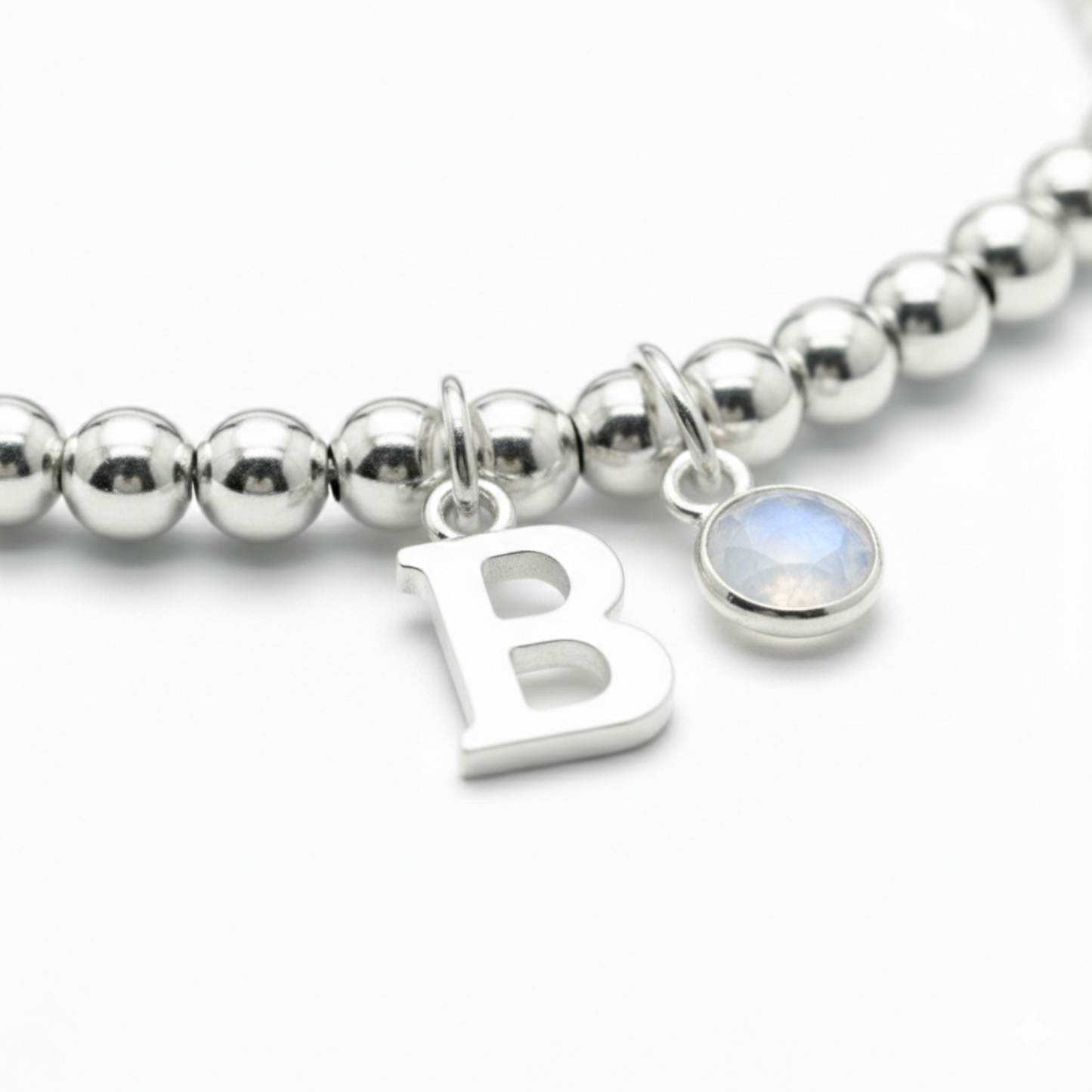 Personalised June birthstone stretch bracelet in sterling silver beads with moonstone charm