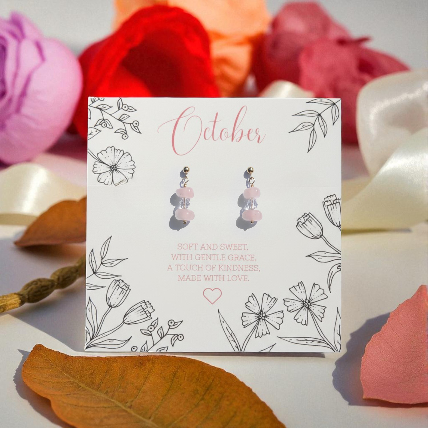 Rose Quartz Earrings displayed on October birthstone message card with floral illustration and colourful flower background.