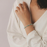 Amazonite and sterling silver beaded bracelet worn on wrist, featuring soft blue amazonite gemstones.