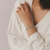 Amazonite and sterling silver beaded bracelet worn on wrist, featuring soft blue amazonite gemstones.