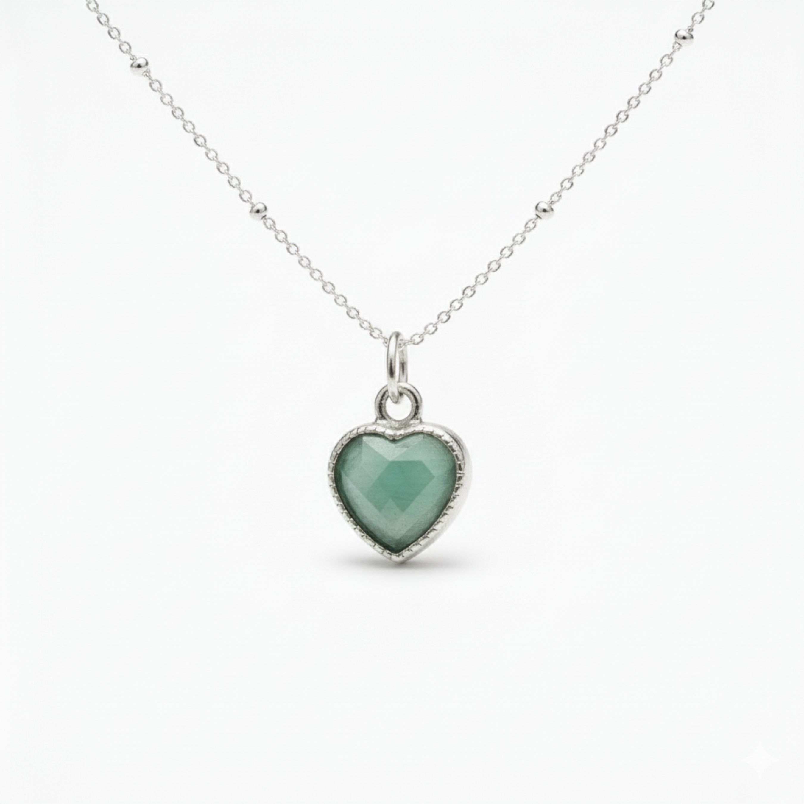 Amazonite gemstone heart charm necklace in sterling silver with soft green stone.