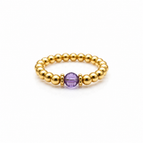 February birthstone Amethyst crystal ring with a faceted purple gemstone set on a gold filled bead ring.