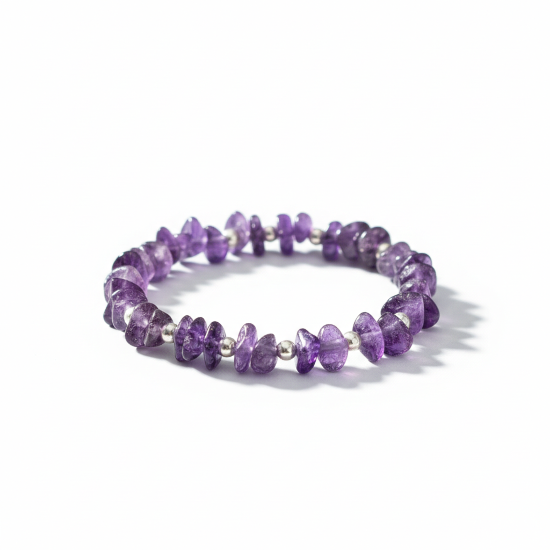 Amethyst crystal stretch bracelet with sterling silver beads, February birthstone jewellery symbolising calm, clarity and protection.