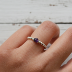 Amethyst bead stretch ring in sterling silver, February birthstone jewellery symbolising calm and clarity.