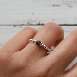 Amethyst bead stretch ring in sterling silver, February birthstone jewellery symbolising calm and clarity.