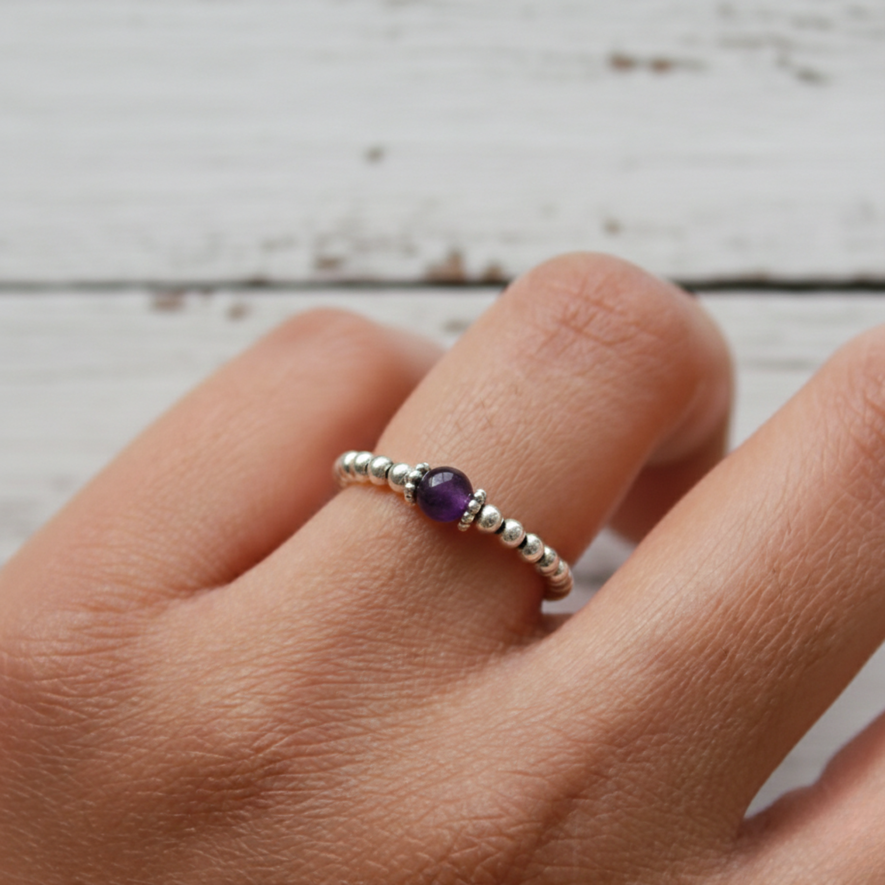 Amethyst bead stretch ring in sterling silver, February birthstone jewellery symbolising calm and clarity.