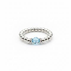 Aquamarine gemstone bead ring with pale blue stone and sterling silver stretch beads.