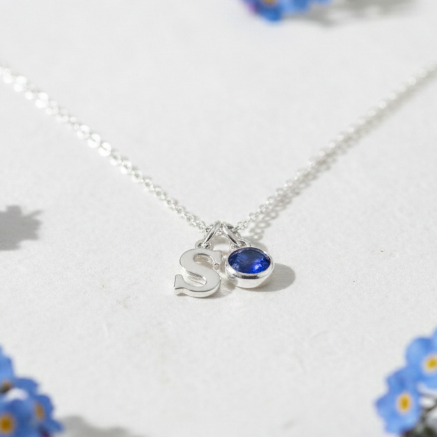 Sapphire birthstone and initial letter necklace in sterling silver, personalised September birthday jewellery gift.