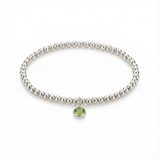 August birthstone beaded bracelet in sterling silver with peridot gemstone detail.