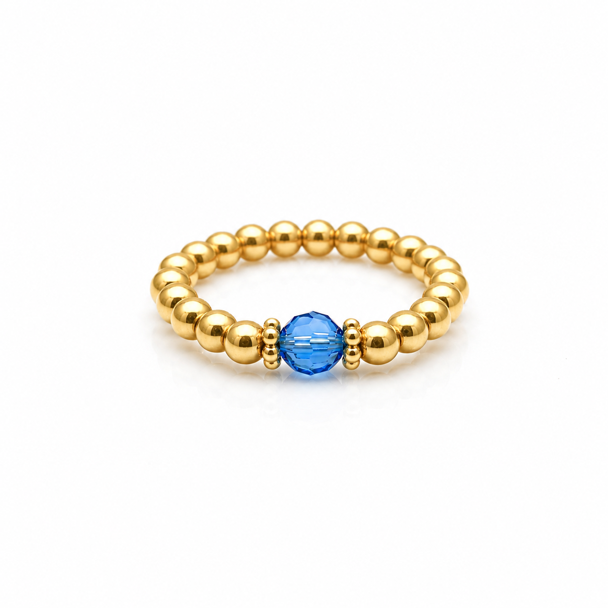 capri blue crystal ring with a faceted blue gemstone set on a gold filled bead ring.