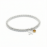 November birthstone citrine bracelet with initial charm on a sterling silver stretch bead bracelet.
