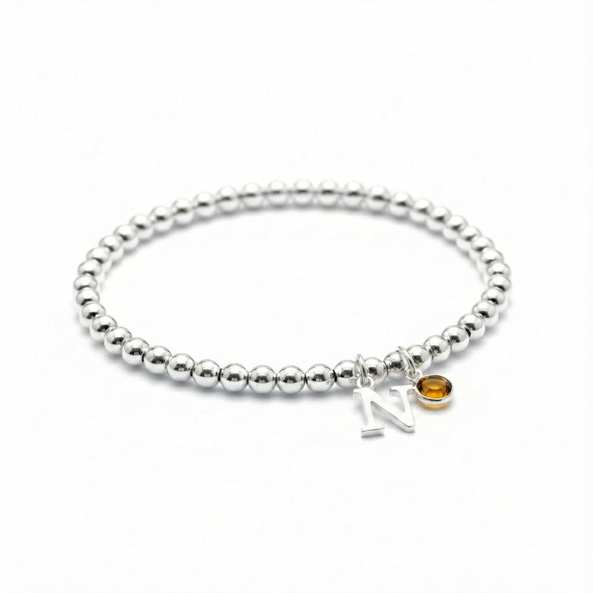 November birthstone citrine bracelet with initial charm on a sterling silver stretch bead bracelet.