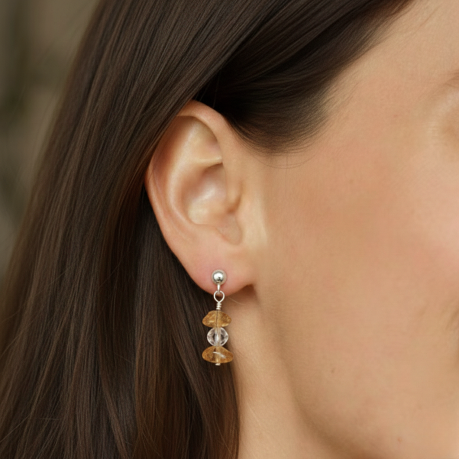Citrine November birthstone earrings worn on ear in sterling silver, elegant golden gemstone jewellery gift for her.