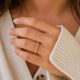 close up of a rose crystal ring with a faceted pink gemstone set on a gold filled bead ring.