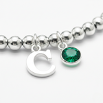 Emerald birthstone and initial charm bracelet in sterling silver