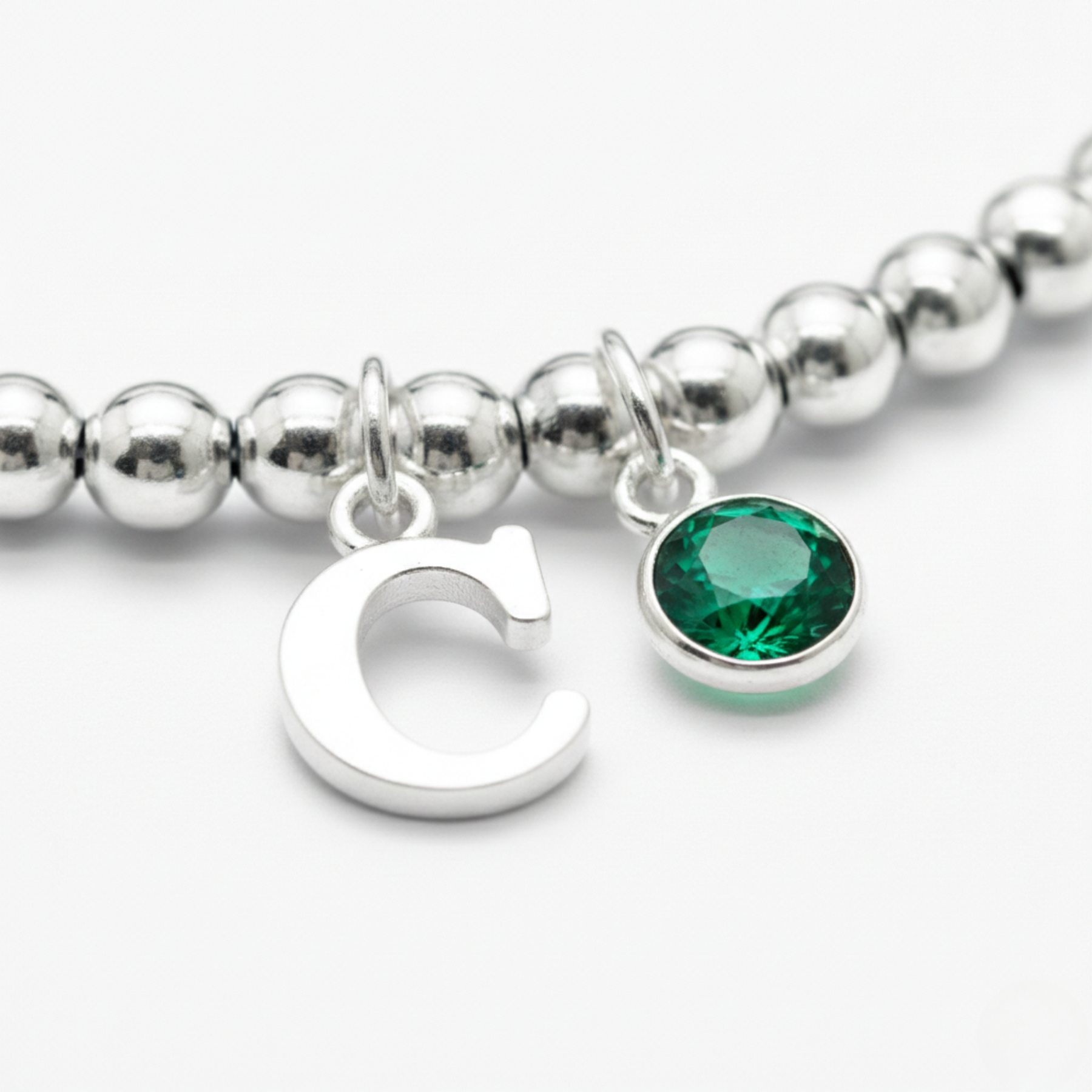 Emerald birthstone and initial charm bracelet in sterling silver
