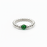 May birthstone emerald crystal ring with a faceted green gemstone set on a sterling silver bead ring.