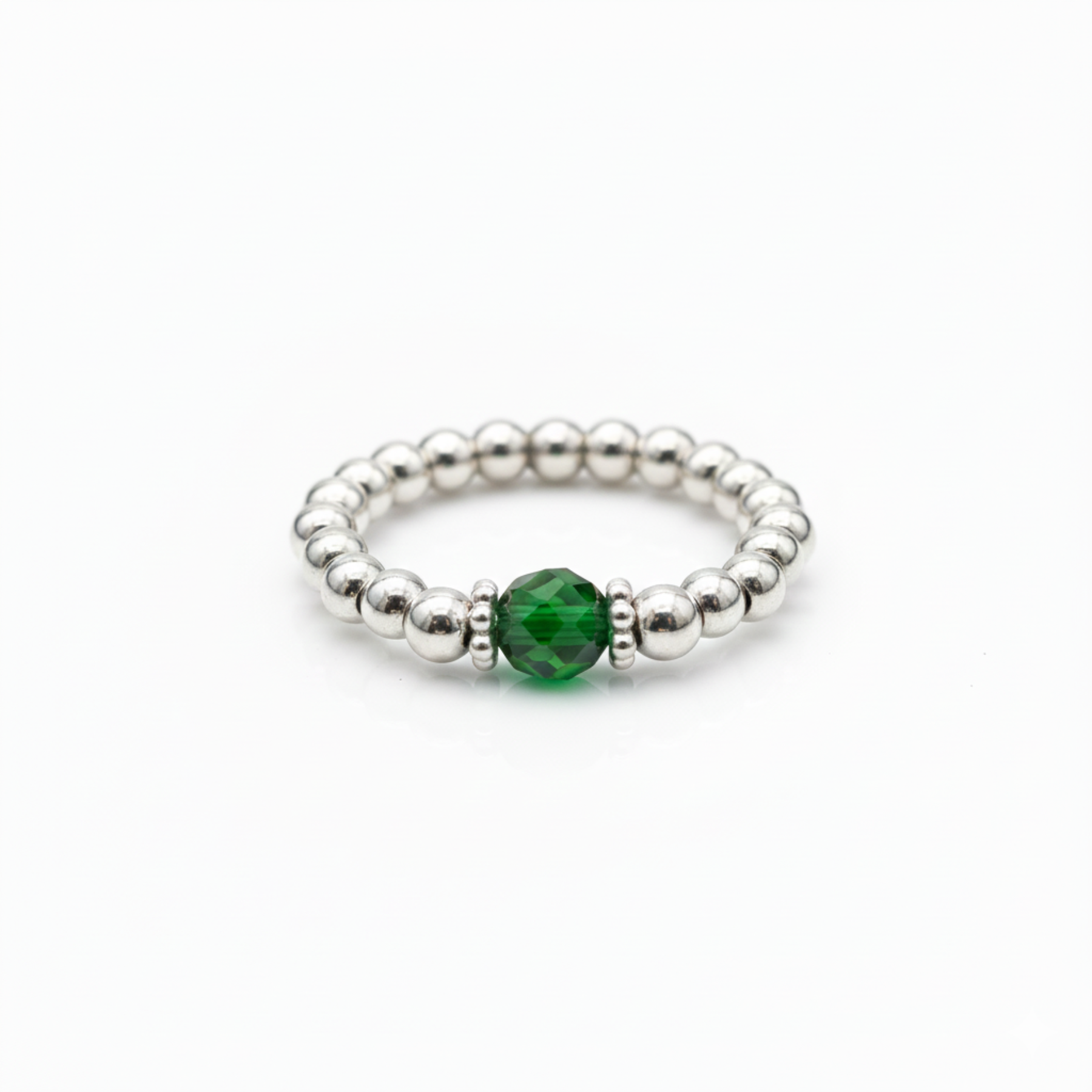 May birthstone emerald crystal ring with a faceted green gemstone set on a sterling silver bead ring.