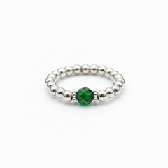 May birthstone emerald crystal ring with a faceted green gemstone set on a sterling silver bead ring.