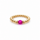 fuchsia crystal ring with a faceted pink gemstone set on a gold filled bead ring