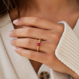 fuchsia crystal ring with a faceted pink gemstone set on a gold filled bead ring.