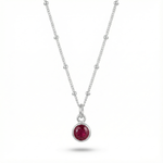 January garnet birthstone pendant necklace with deep red gemstone on sterling silver chain.