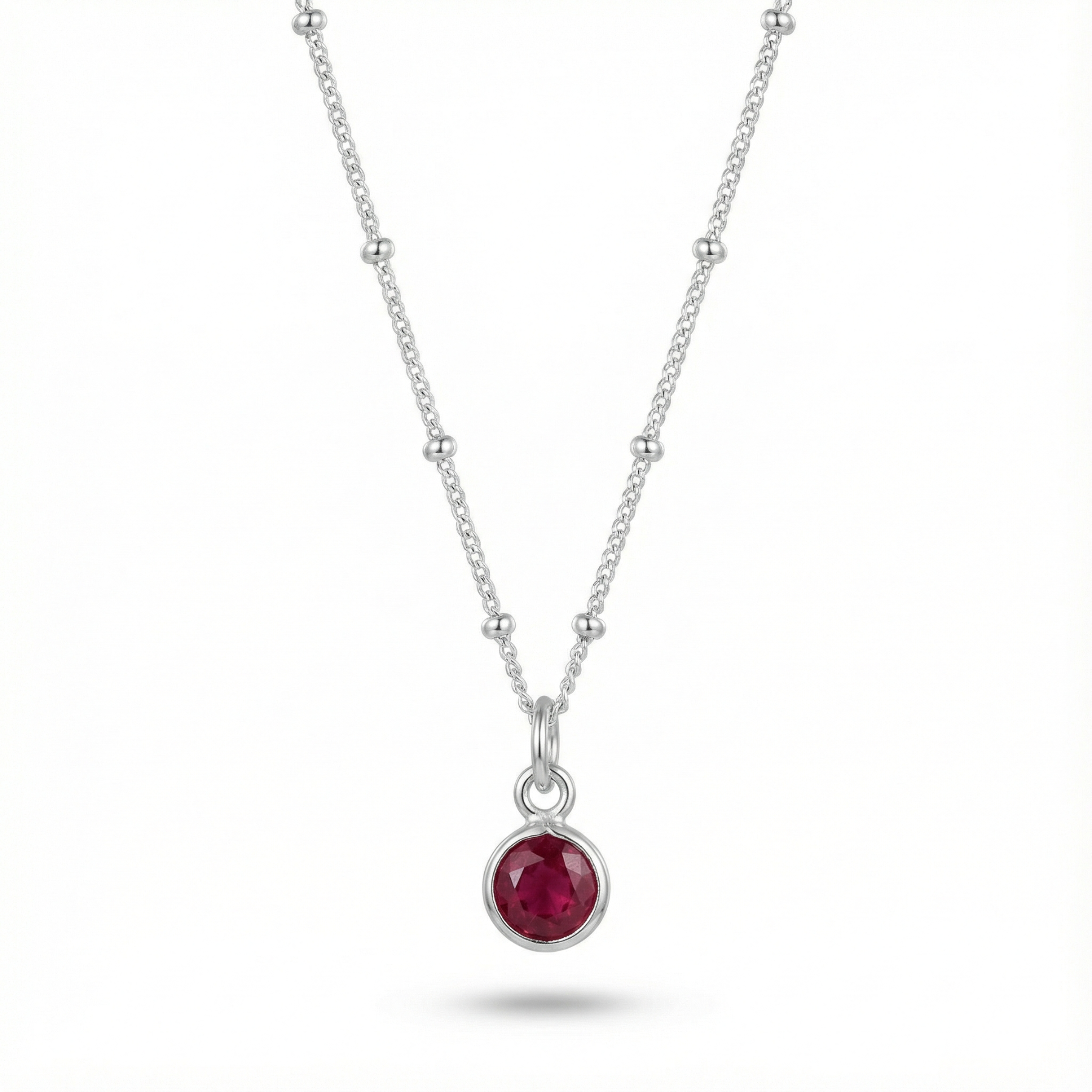 January garnet birthstone pendant necklace with deep red gemstone on sterling silver chain.