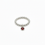 stretchy sterling silver bead ring with red gemstone charm - january garnet birthstone 