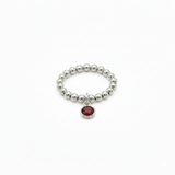 stretchy sterling silver bead ring with red gemstone charm - january garnet birthstone 