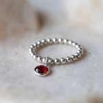 Garnet charm ring in sterling silver, January birthstone stretch ring UK