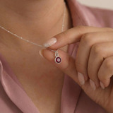 January birthstone garnet necklace worn on chain, featuring a deep red garnet gemstone in sterling silver.