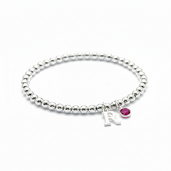 July ruby birthstone and initial sterling silver bead stretch bracelet, personalised birthday gift