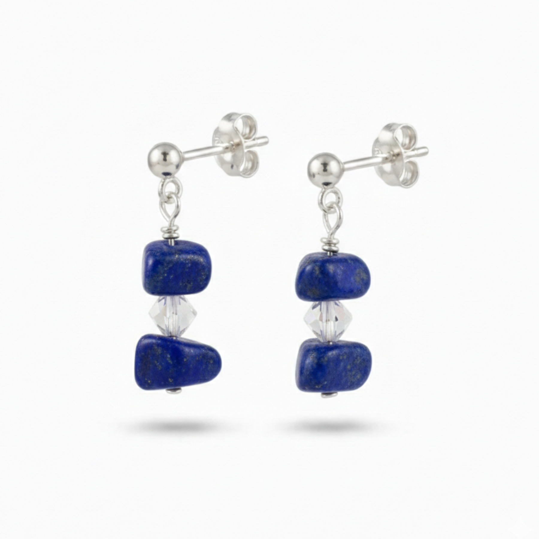 Lapis lazuli gemstone drop earrings in sterling silver with deep celestial blue stones and subtle golden flecks, meaningful September birthstone jewellery.