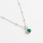Personalised May birthstone emerald necklace with green gemstone charm on a fine sterling silver chain.