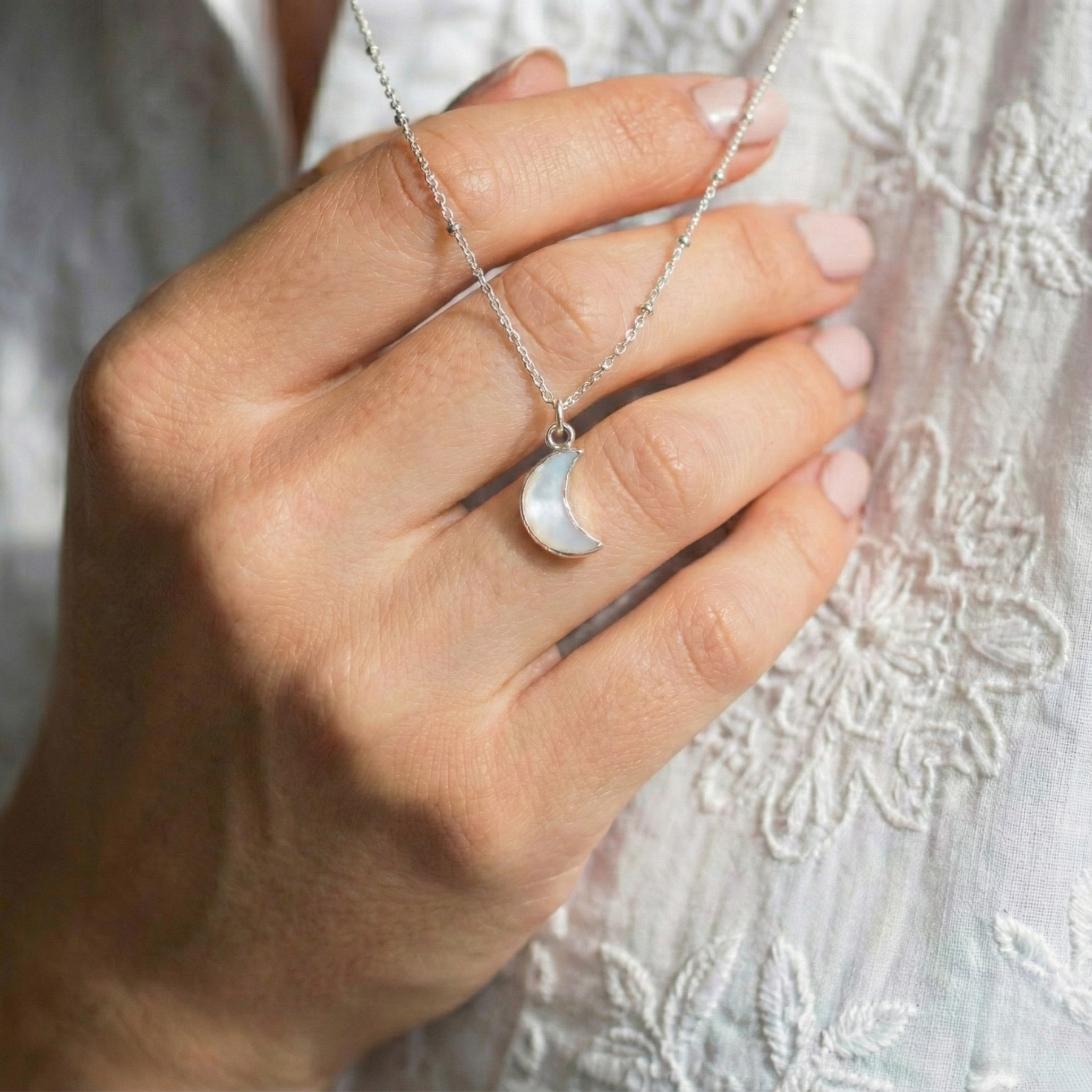 Moonstone pendant necklace featuring a glowing white gemstone on a fine sterling silver chain.