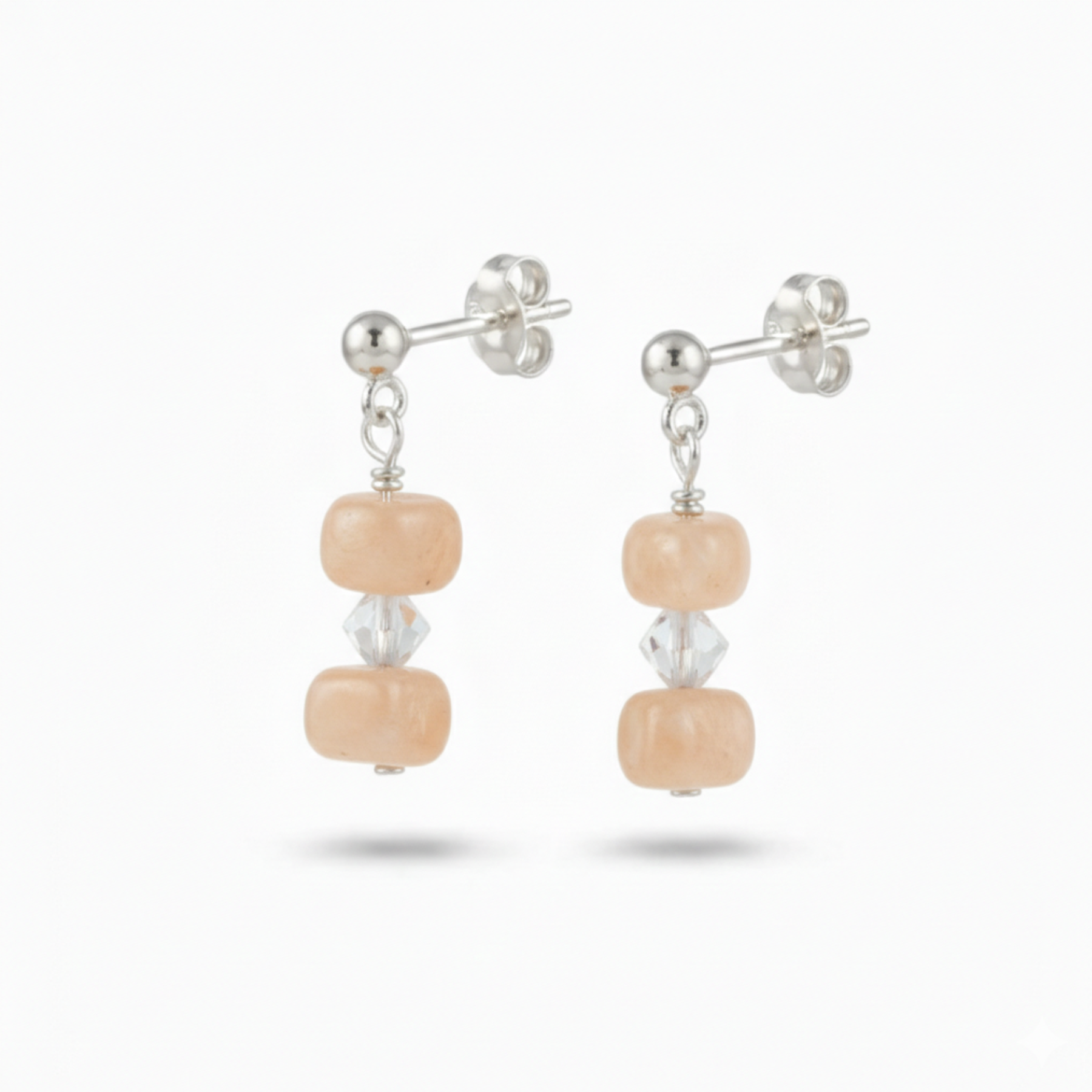 Peach moonstone sterling silver earrings with soft salmon shimmer, elegant feminine gemstone jewellery for everyday wear or wedding styling.