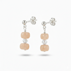 Peach moonstone sterling silver earrings with soft salmon shimmer, elegant feminine gemstone jewellery for everyday wear or wedding styling.